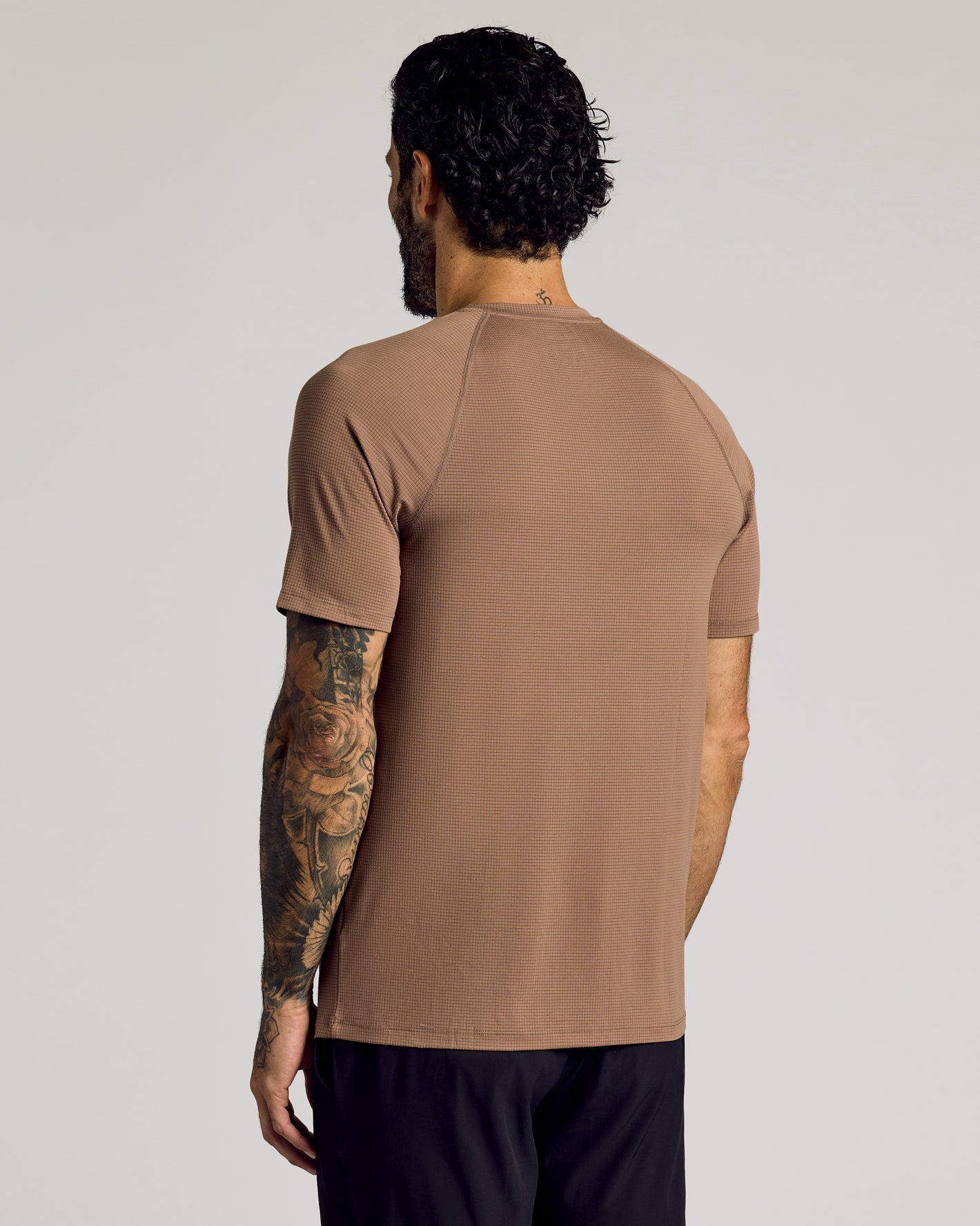 Man in Alpaca Active Mesh Crew with floral sleeve tattoo.