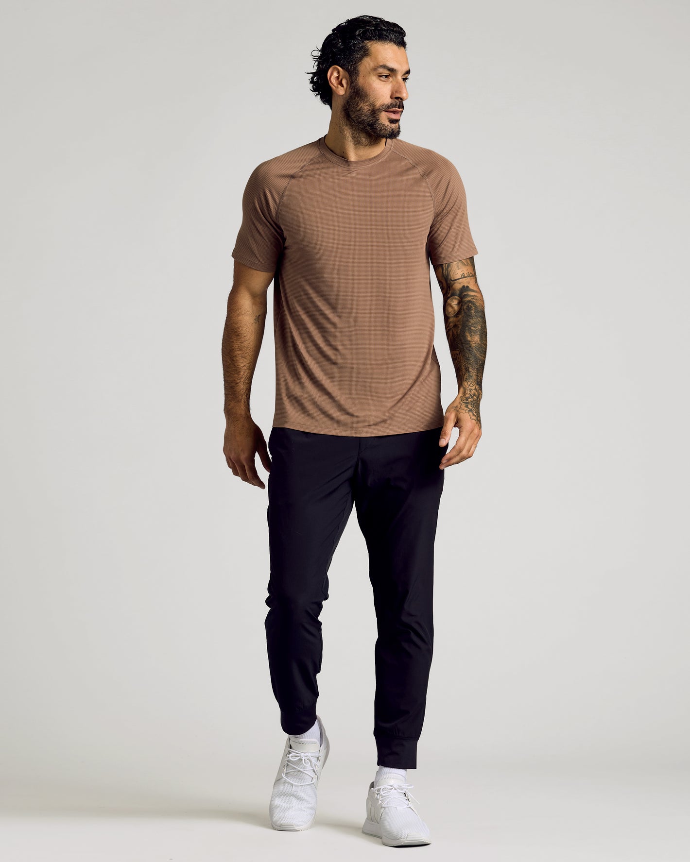 Man in Alpaca Active Mesh Crew, slim joggers, white sneakers.