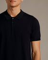 Man wearing All Black Dressy Polo from 3-Pack; sleek, short-sleeve design.