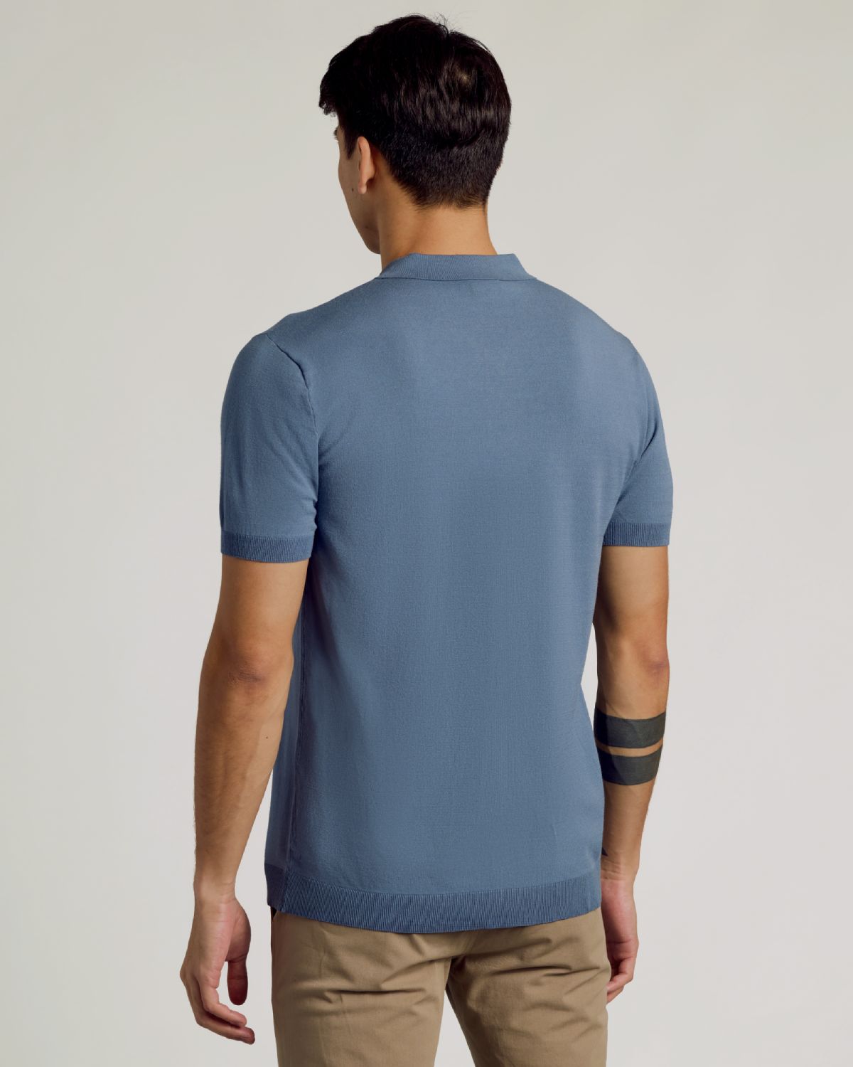 Back view of man in Fiord Dressy Polo and tan chinos.