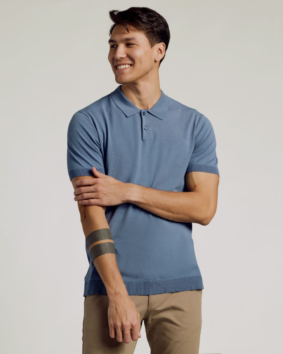 Man wearing Fiord Dressy Polo, smiling with relaxed expression.