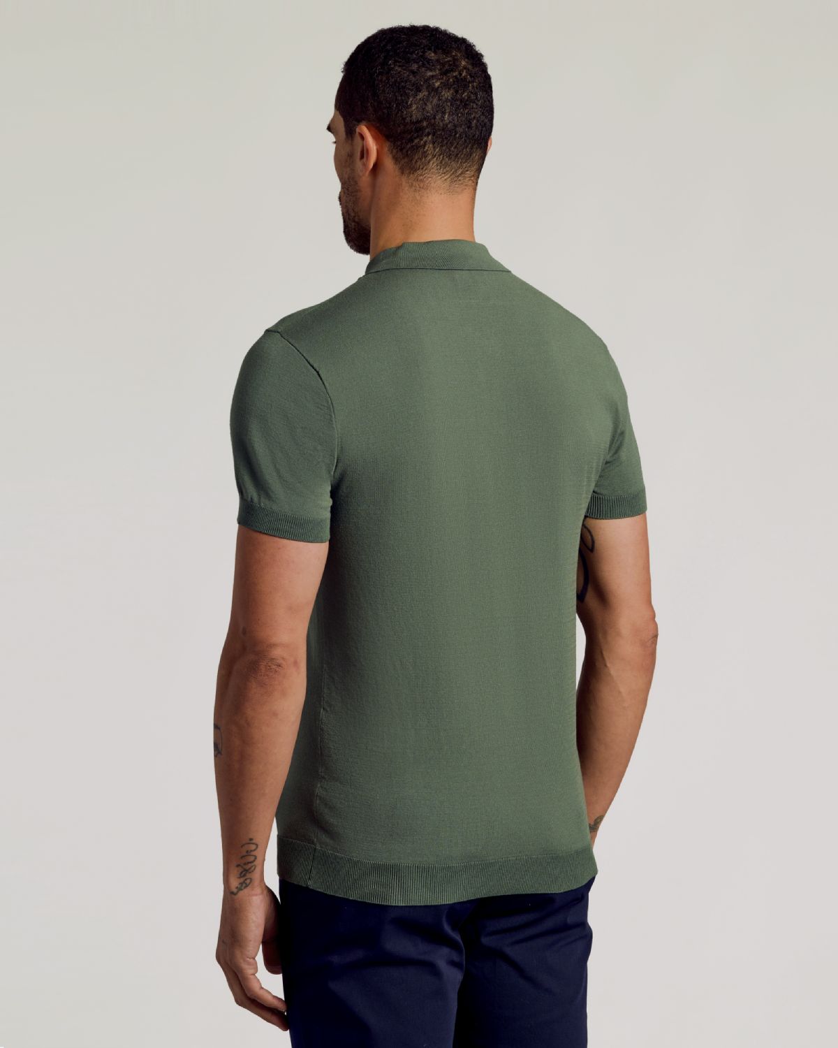 Moss Dressy Polo shown from the back on a model.