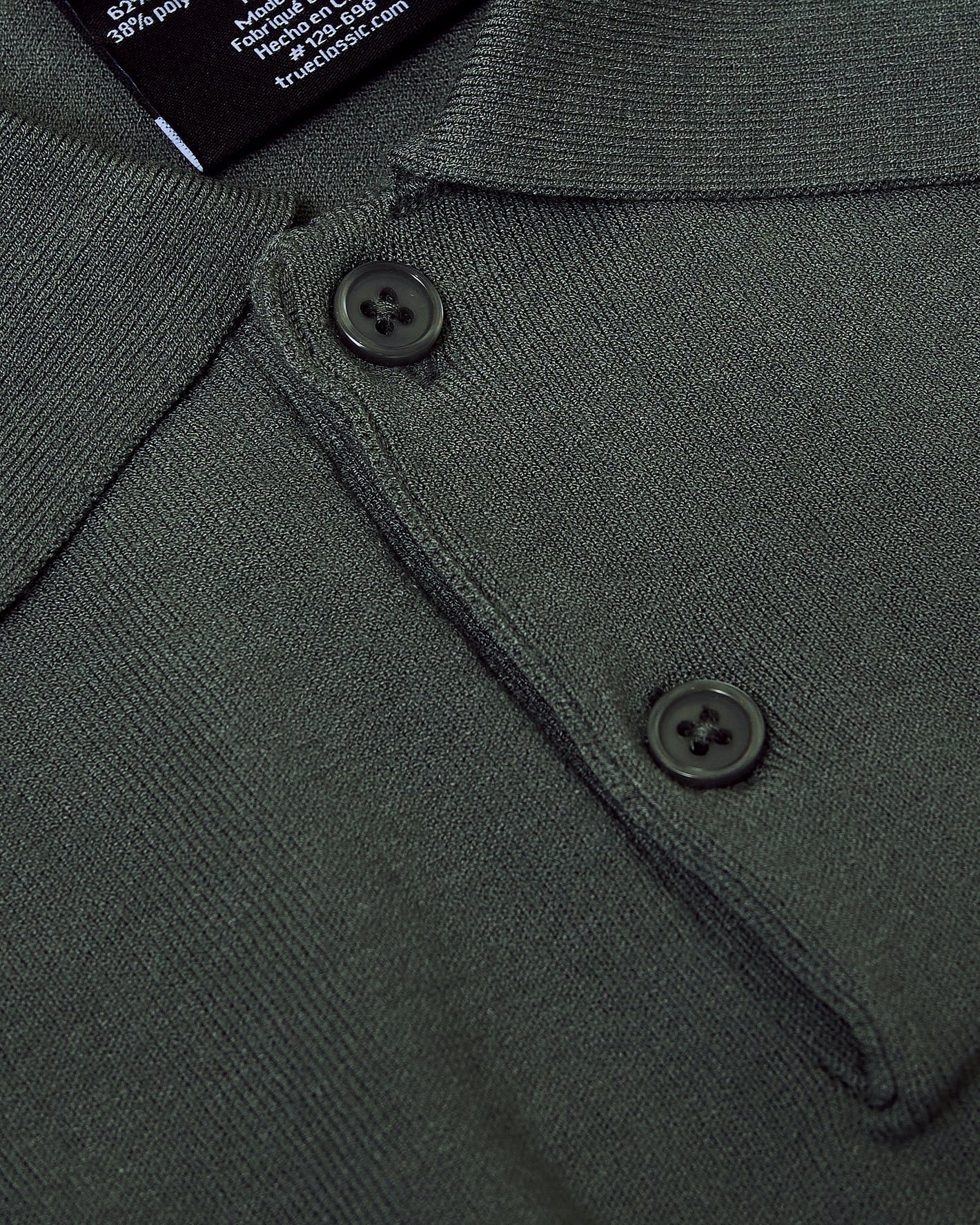 Moss Dressy Polo close-up showing knit texture and two-button placket.