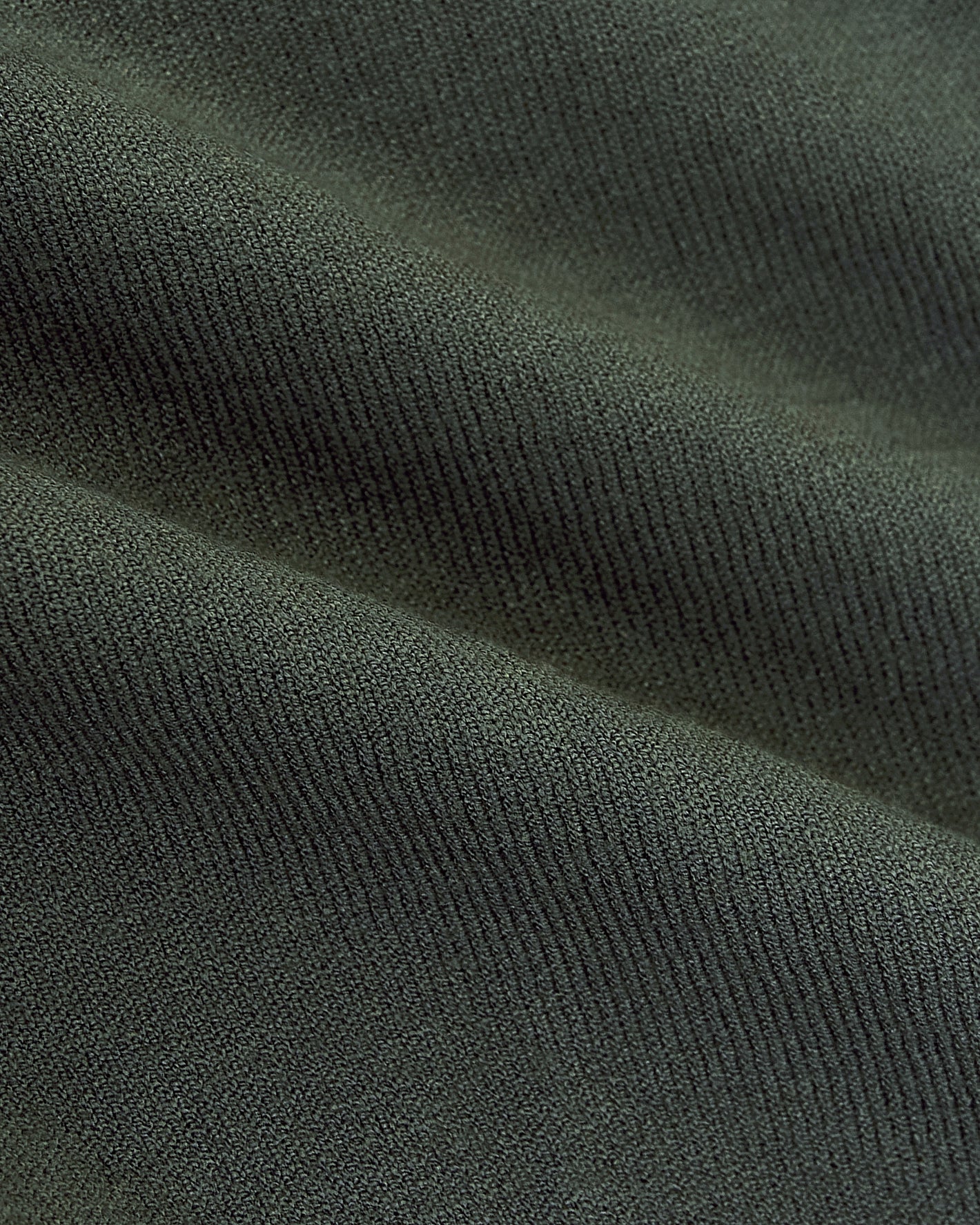 Moss Dressy Polo fabric close-up, showcasing fine knitted texture.