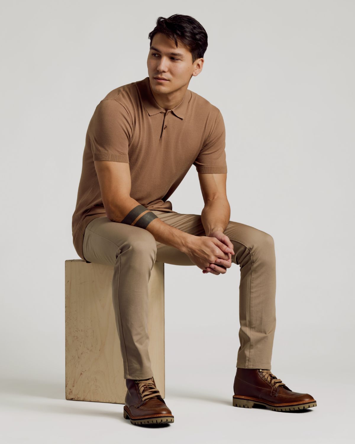 Young man in Truffle Dressy Polo and beige chinos.