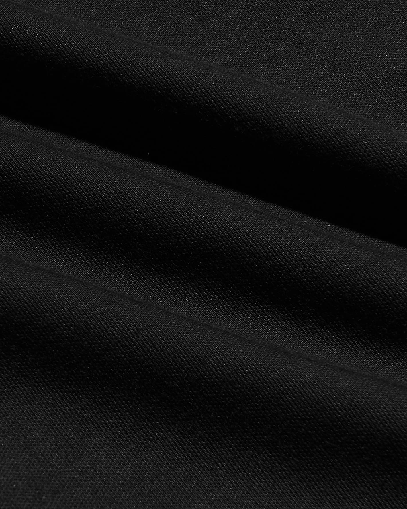 Close-up view of soft black fabric texture showcasing smooth weave and quality material from the All Black Pima Cotton Blend Crew 7-Pack men's basics.