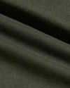 Dark green fabric with visible texture and folds