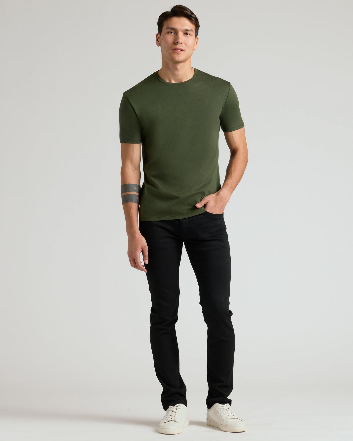 Young man wearing Premium Pima Crew 7-Pack olive green tee.