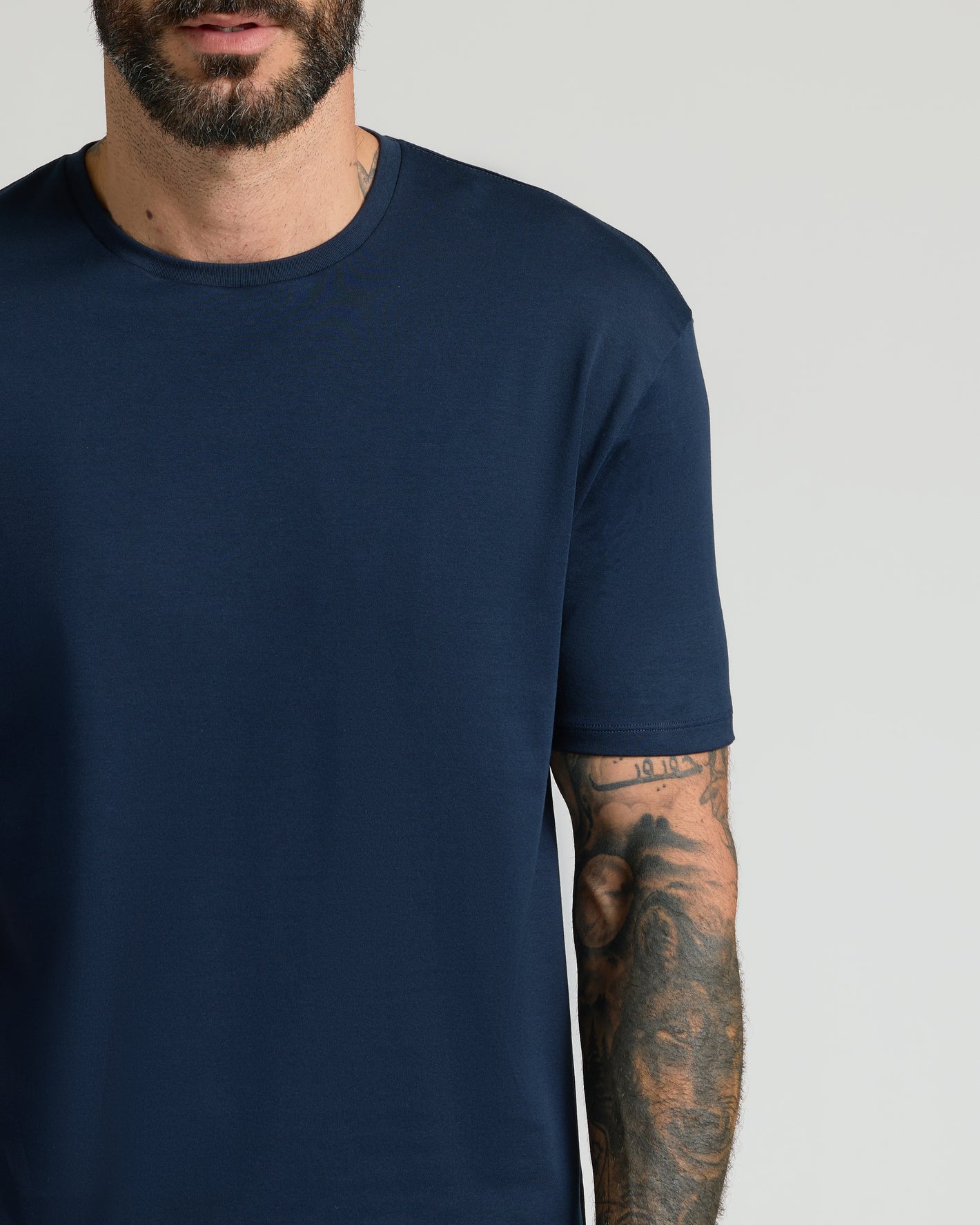 Navy & Ether Premium Pima Crew Neck T-shirt on tattooed man.
