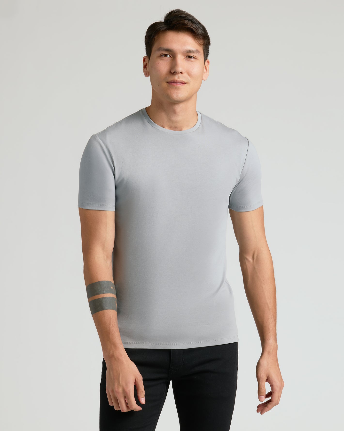 Young man wearing Premium Pima Crew 7-Pack gray tee.