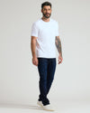 Man wearing a white crew neck t-shirt paired with dark jeans and white sneakers, showcasing the Black & White Pima Cotton Blend Crew 7-Pack in a casual, modern style.