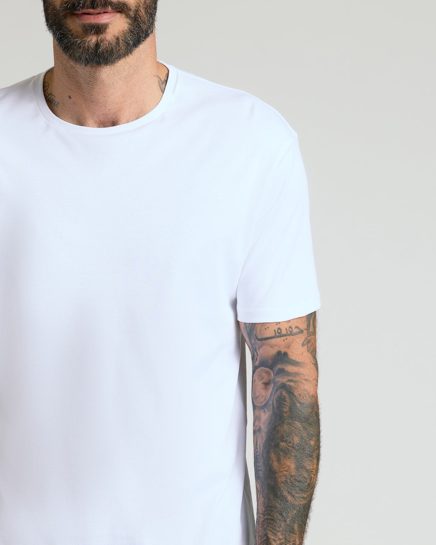 Pima Cotton Blend Crew 4-Pack on tattooed man's upper body.