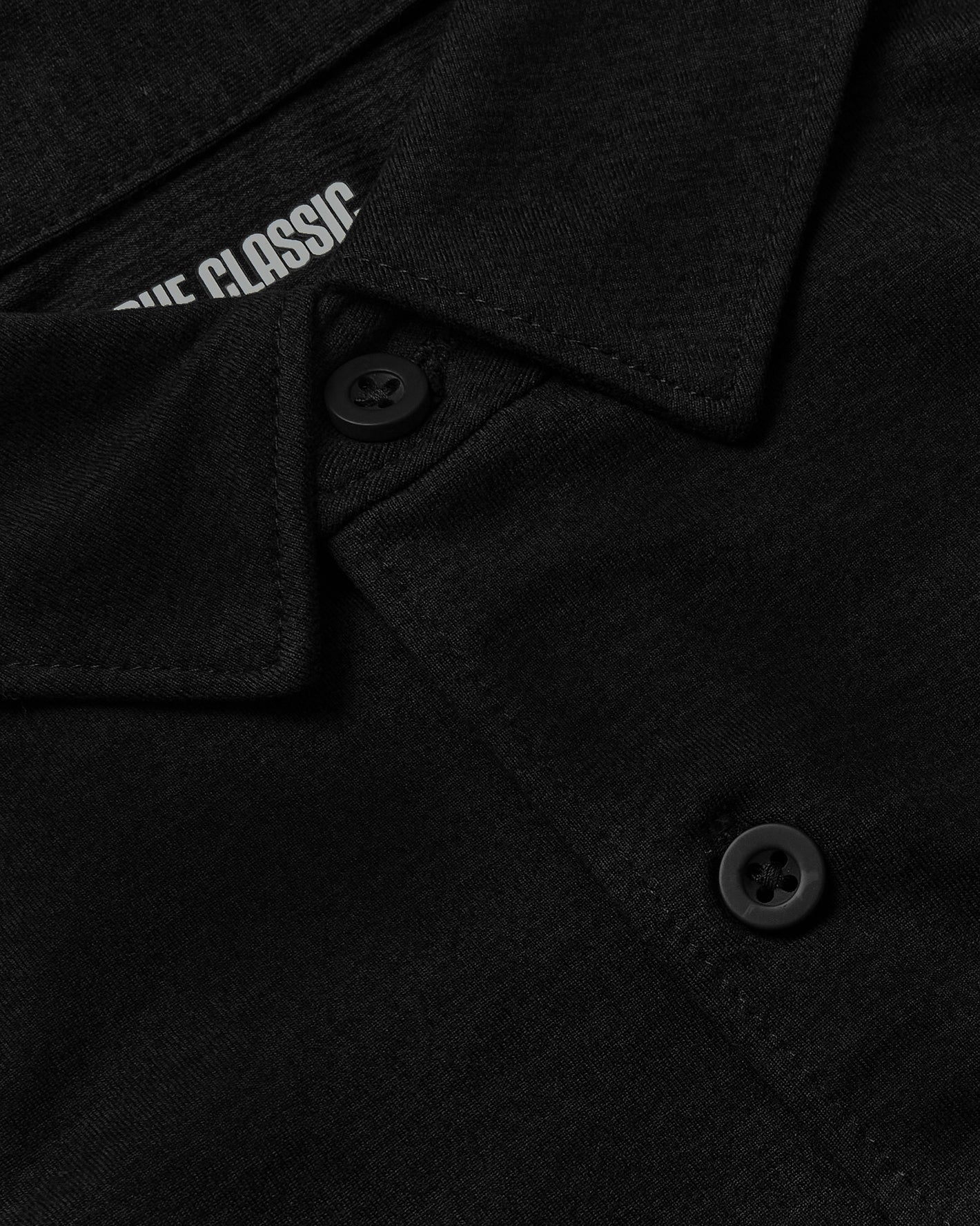 Black Short Sleeve Comfort Knit Shirt with buttons and classic collar.
