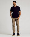 Man in Black Curved Hem Classic Crew Neck T-shirt, khaki pants.