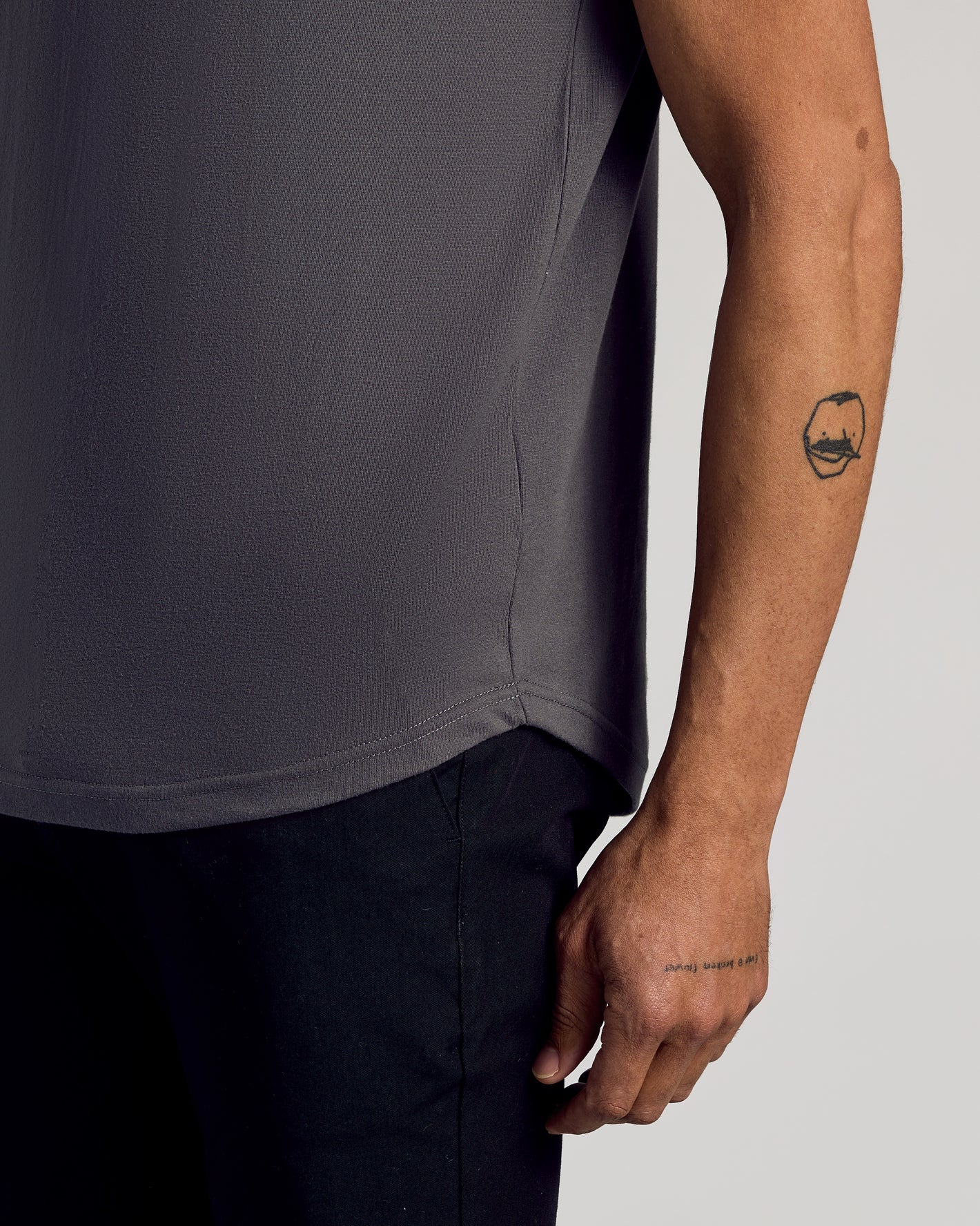 Carbon Curved Hem Classic Crew Neck, bicep-hugging fit, visible tattoos.