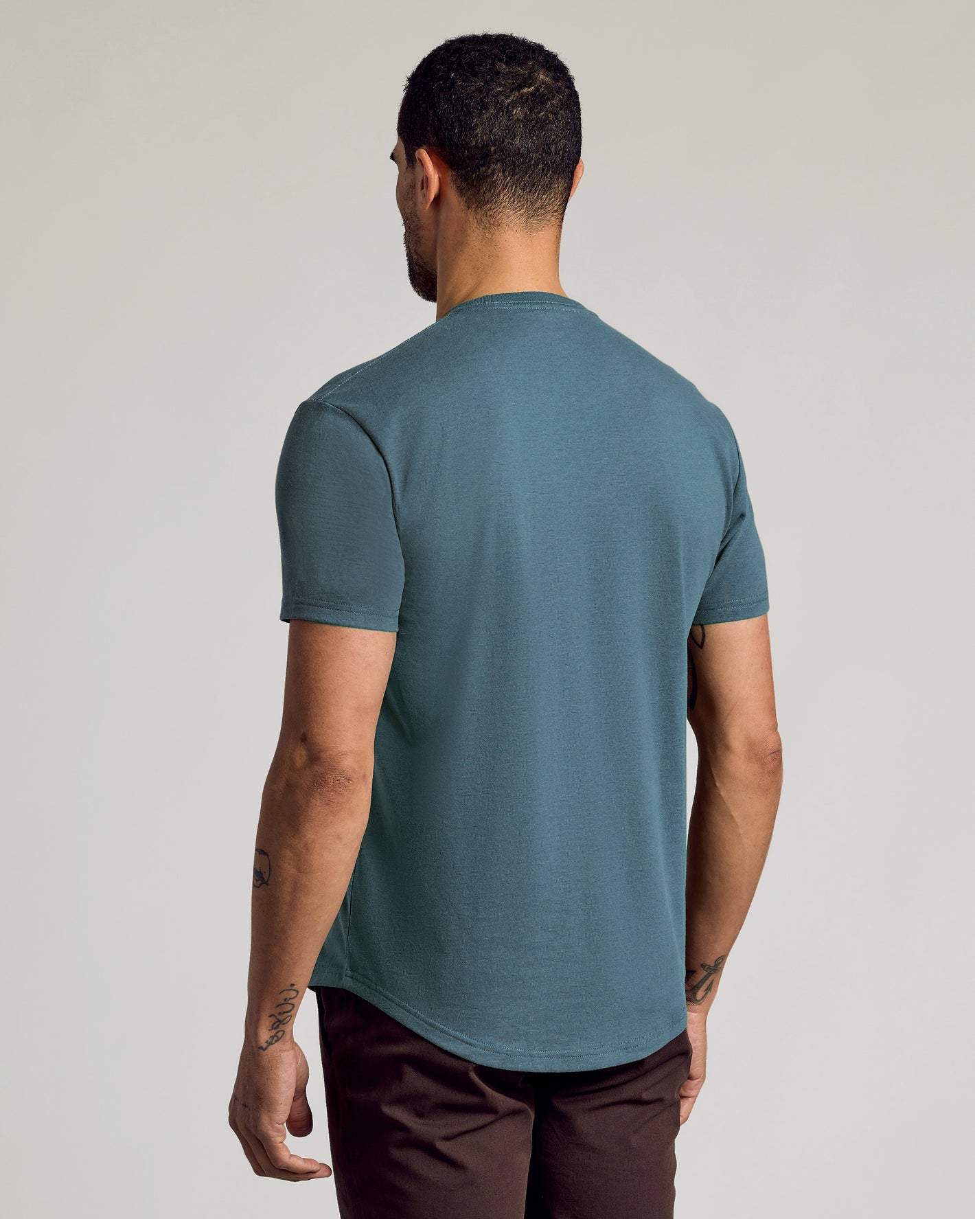 Neptune Curved Hem Classic Crew Neck worn by man from behind.