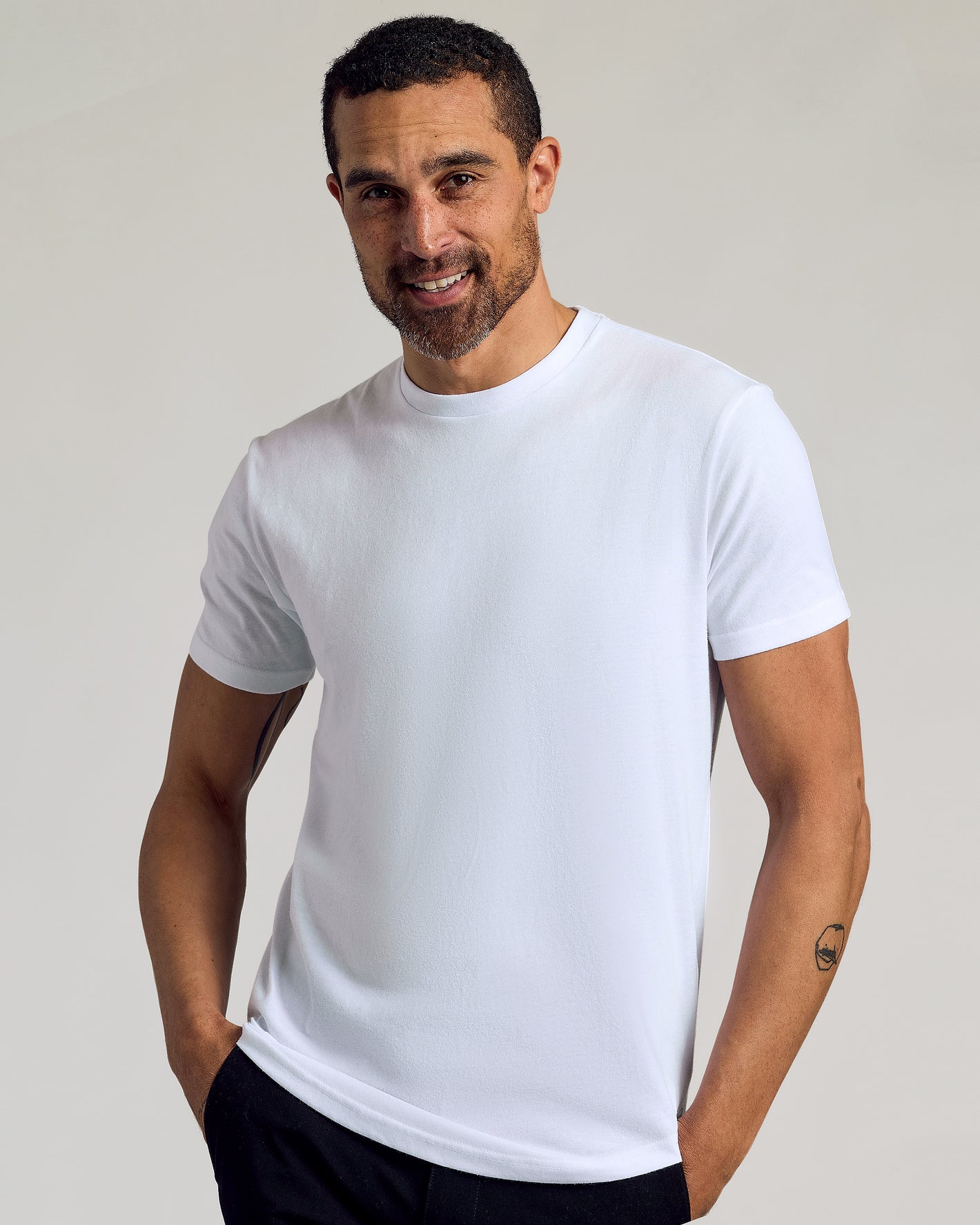 White Curved Hem Classic Crew Neck 6-Pack worn by smiling man.