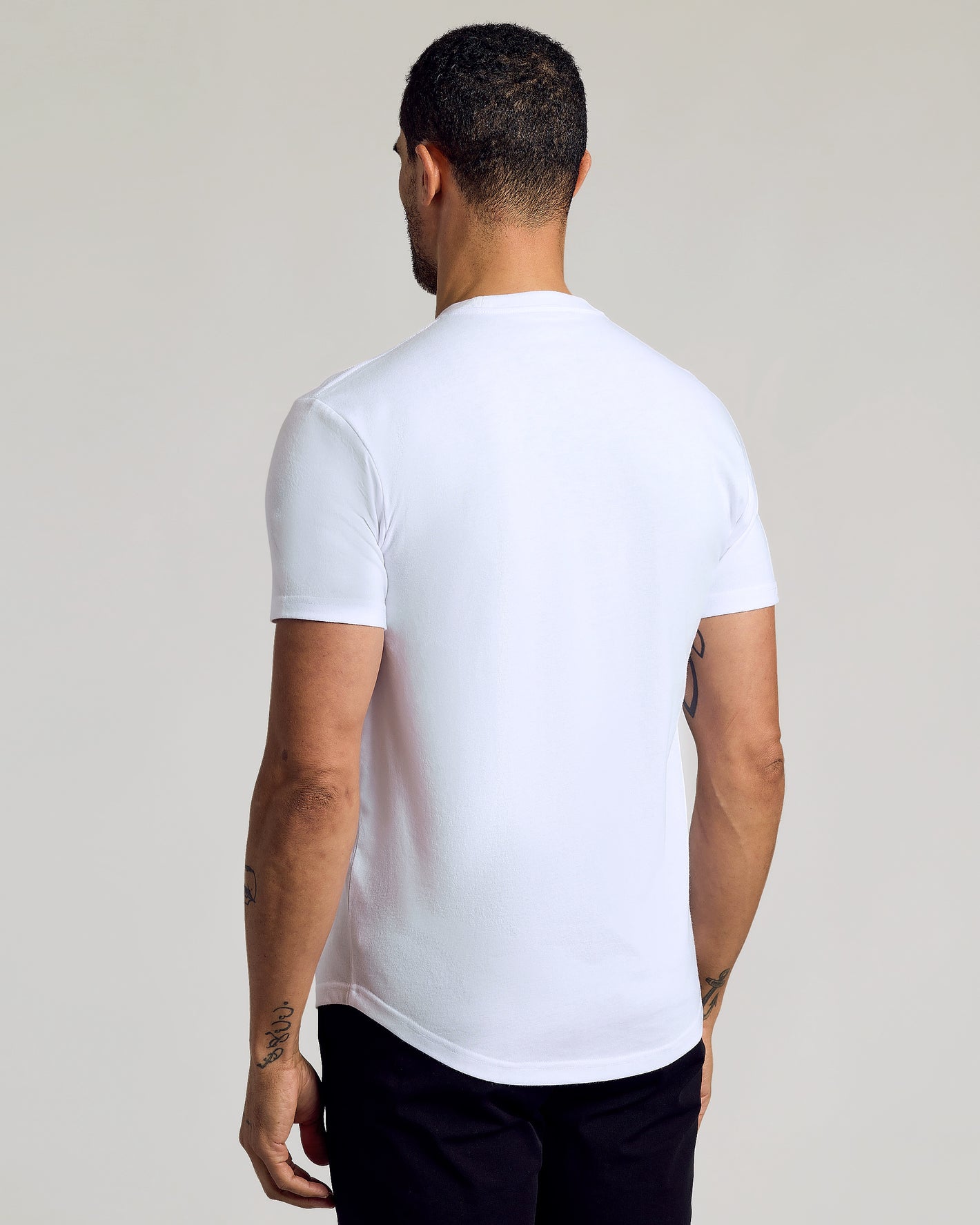 Back view of man in Black & White Curved Hem Classic Crew Neck.