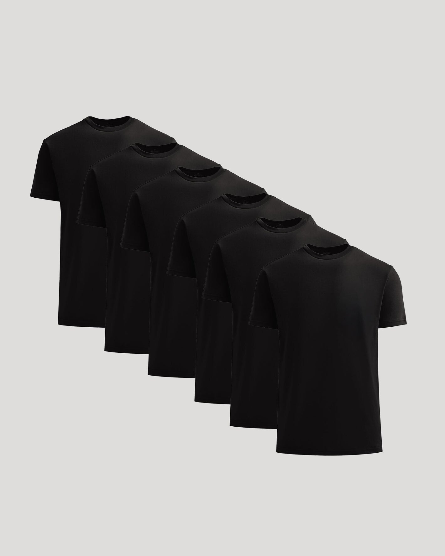 Set of six black t-shirts on a light gray background
