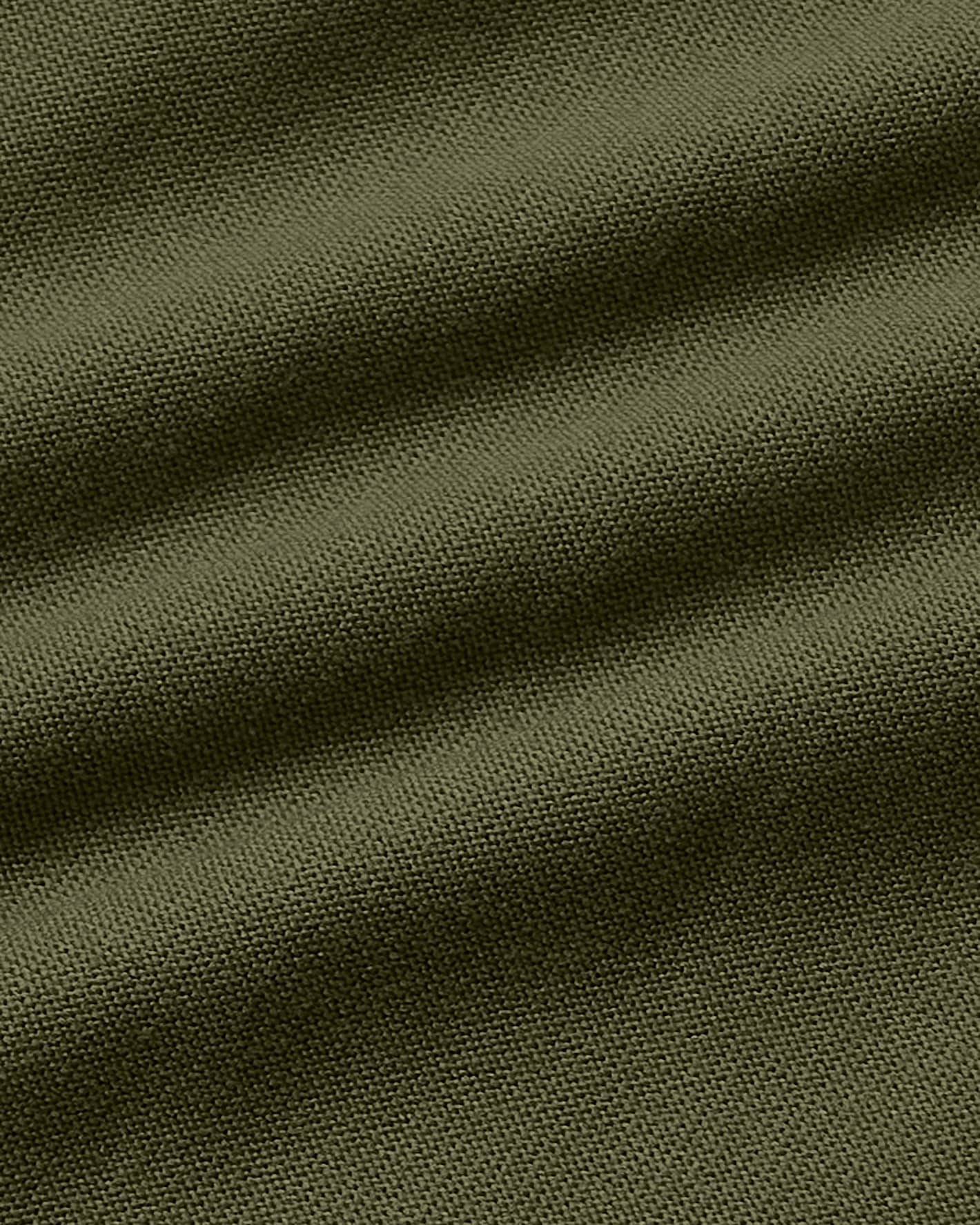 A close-up of olive green fabric with a fine woven texture and soft diagonal folds.