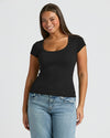 Woman wearing Womens Black Ribbed U-Neck Tee with light-wash jeans.