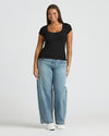 Womens Black Ribbed U-Neck Tee worn with jeans and white shoes.