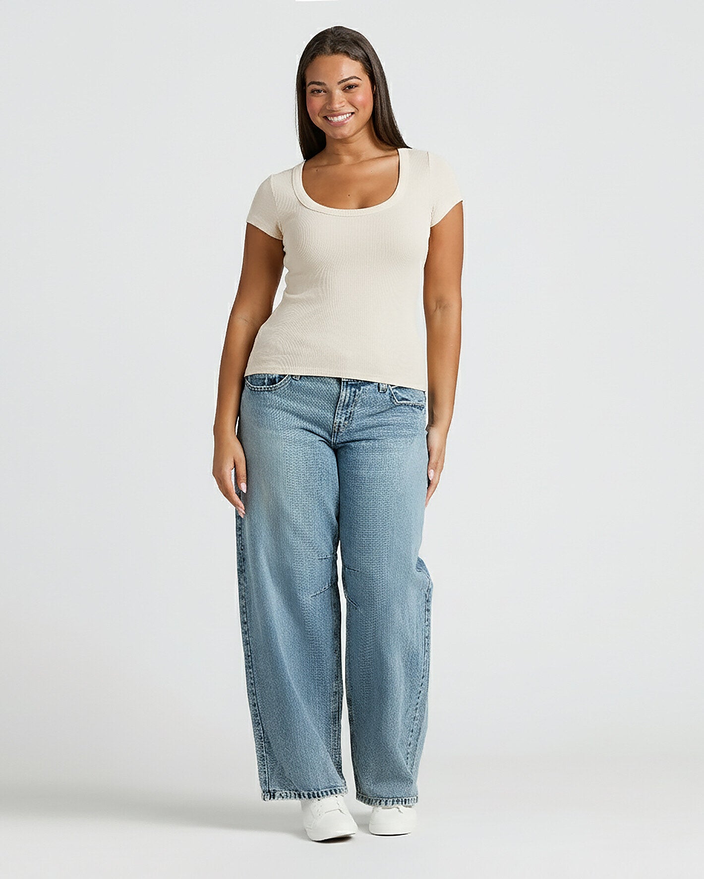 Woman wearing Womens Oatmeal Ribbed U-Neck Tee, blue jeans, and sneakers.