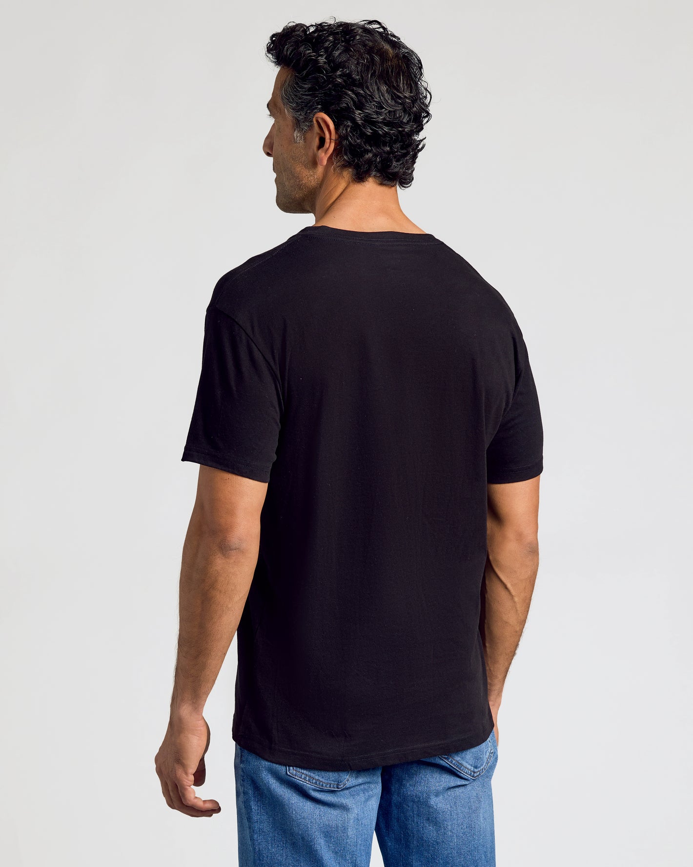 Man wearing Black & White V-Neck 10-Pack shirt, back view.