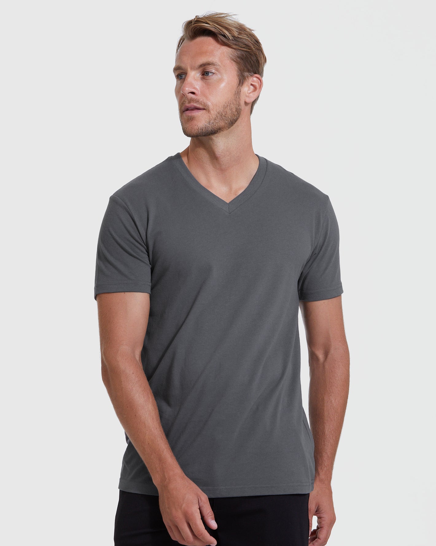 Man modeling Staple Short Sleeve V-Neck Tee in charcoal gray.
