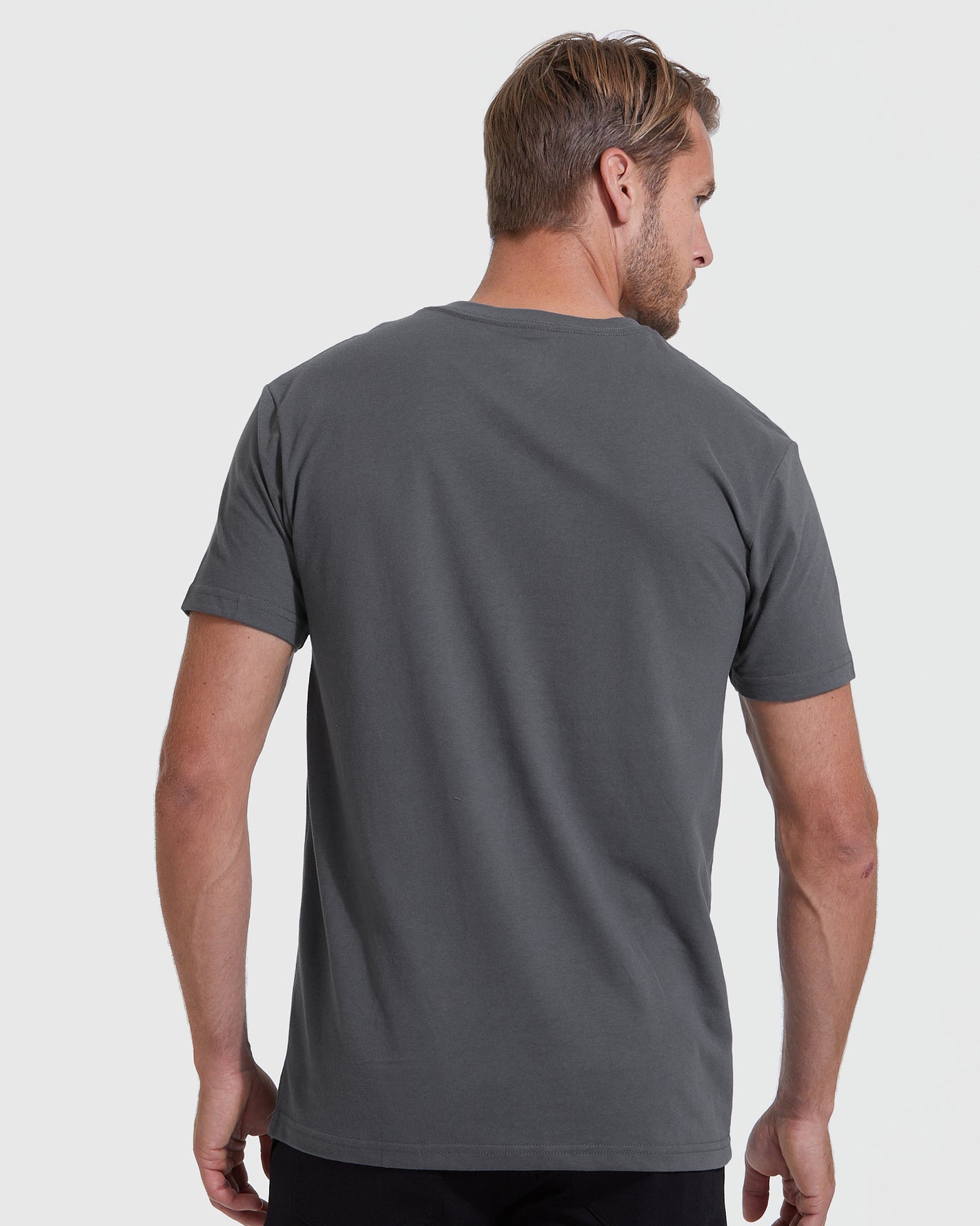 Man in dark-gray Staple Short Sleeve V-Neck Tee, back view.