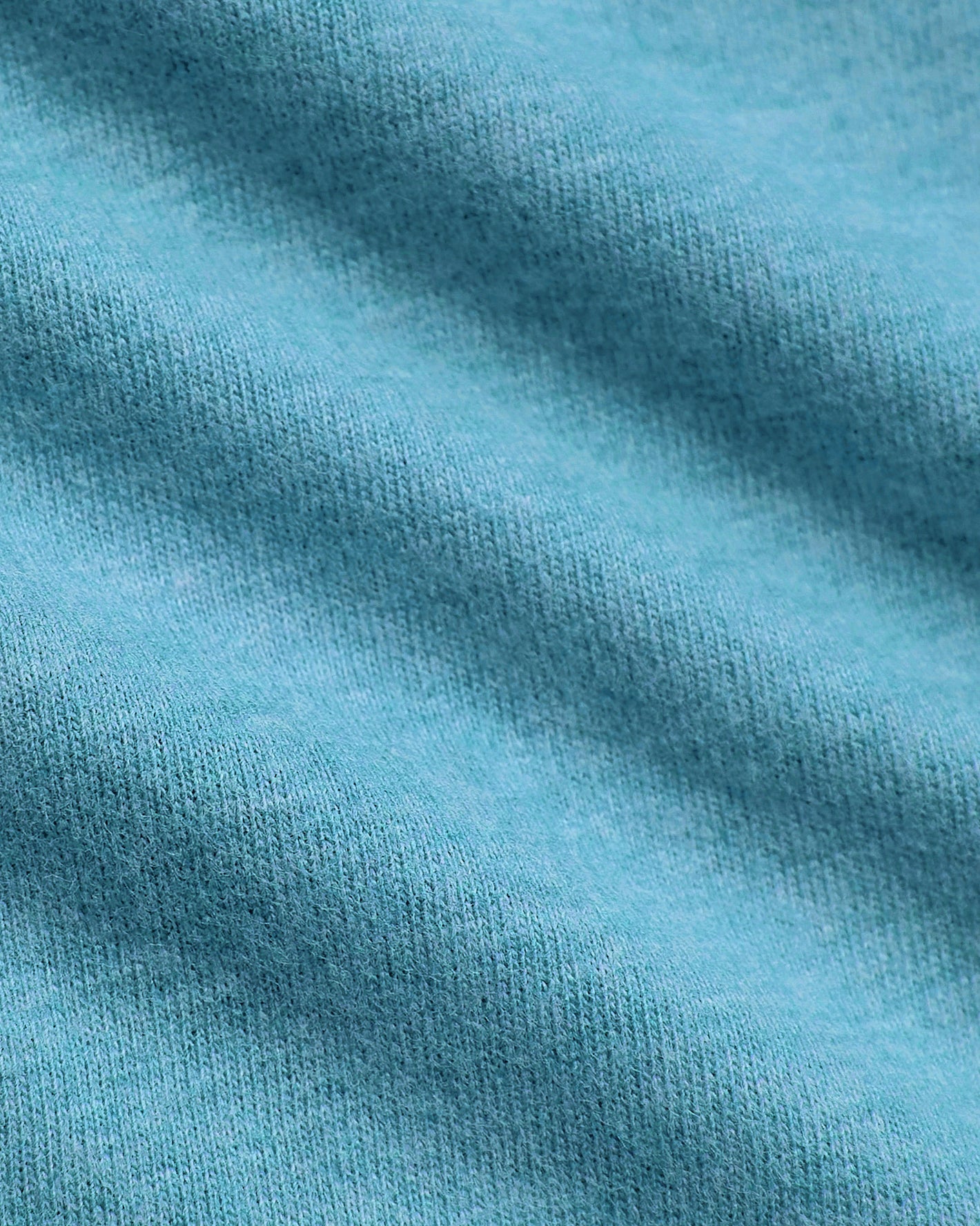 Macro shot of Dark Heather Harbor Classic V-Neck's soft knit texture.