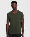 Man wearing Dark Olive V Neck T Shirt, relaxed pose.