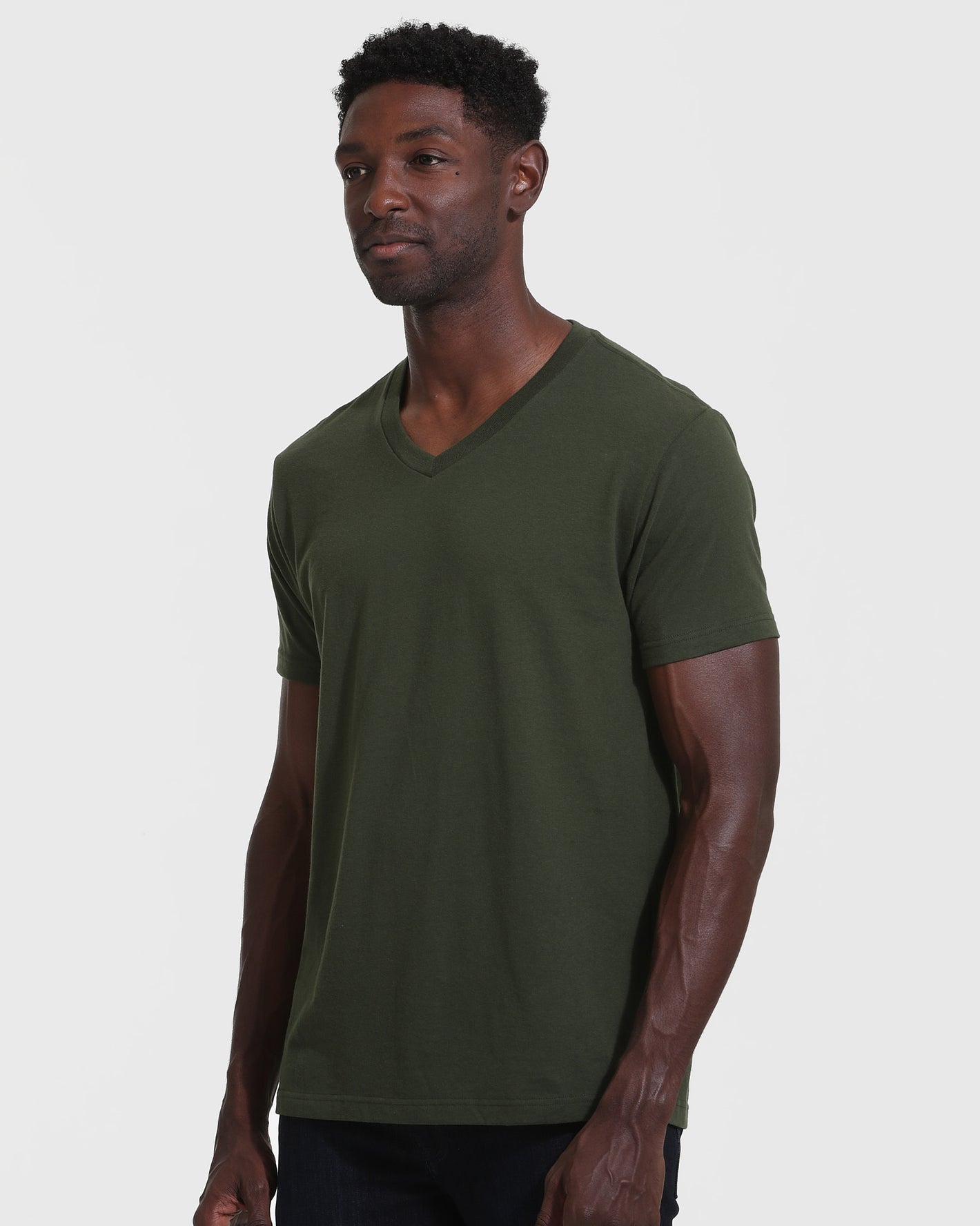 Dark Olive V Neck T Shirt worn by male model, relaxed pose.