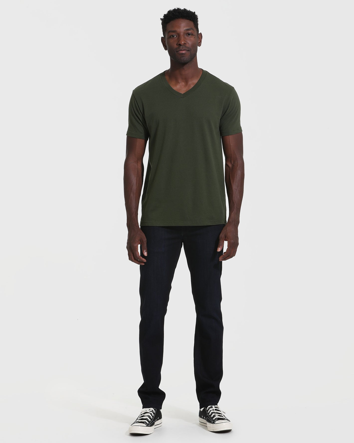 Model wearing Dark Olive V Neck T Shirt and indigo jeans.