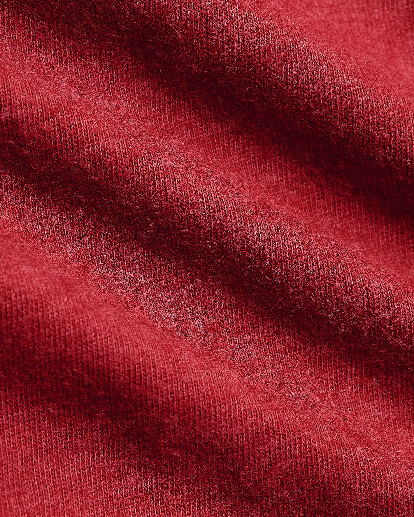 Close-up of Dark Heather Lava Classic V-Neck's fine red knit texture.
