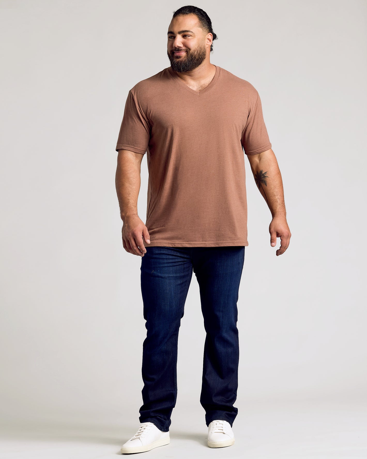 Man in Dark Heather Sepia Classic V-Neck with white sneakers.