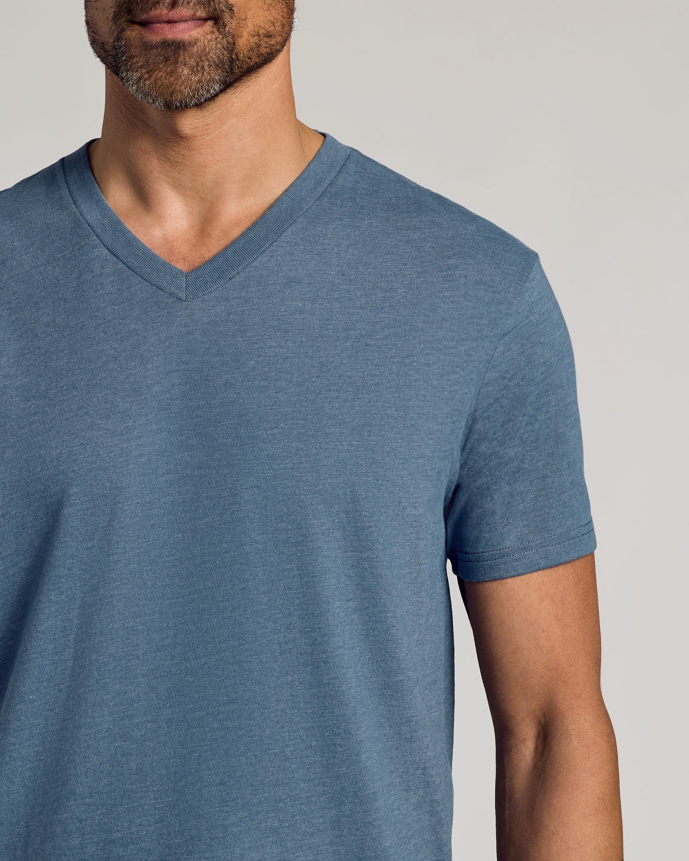 Man wearing Dark Heather Tempest Classic V-Neck, emphasizing fit and comfort.
