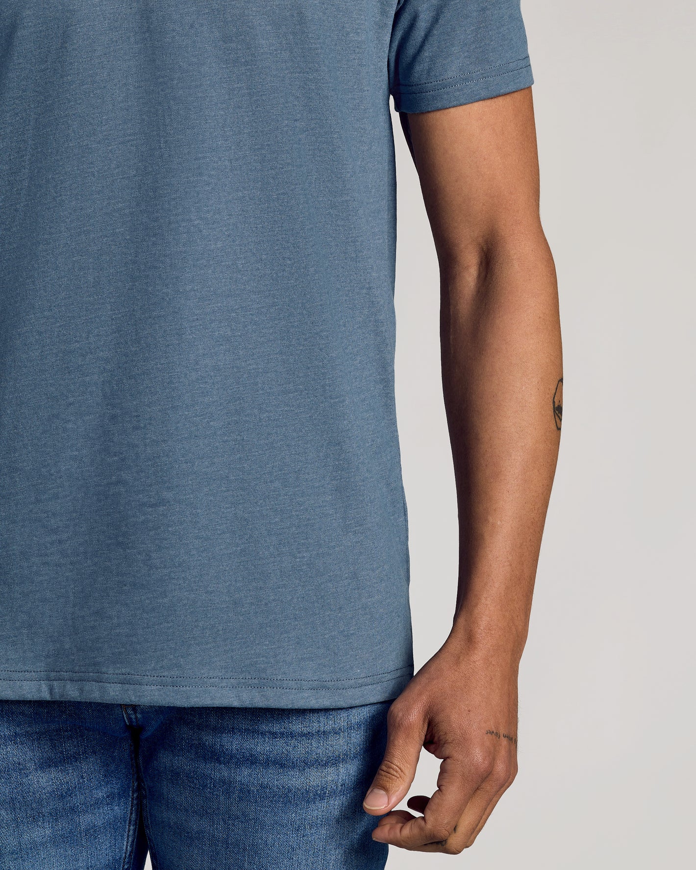 Dark Heather Tempest Classic V-Neck on person, showcasing fit and tattoo.