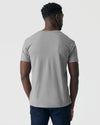 Person wearing Glacier Gray Classic V-Neck and dark blue jeans, back view.
