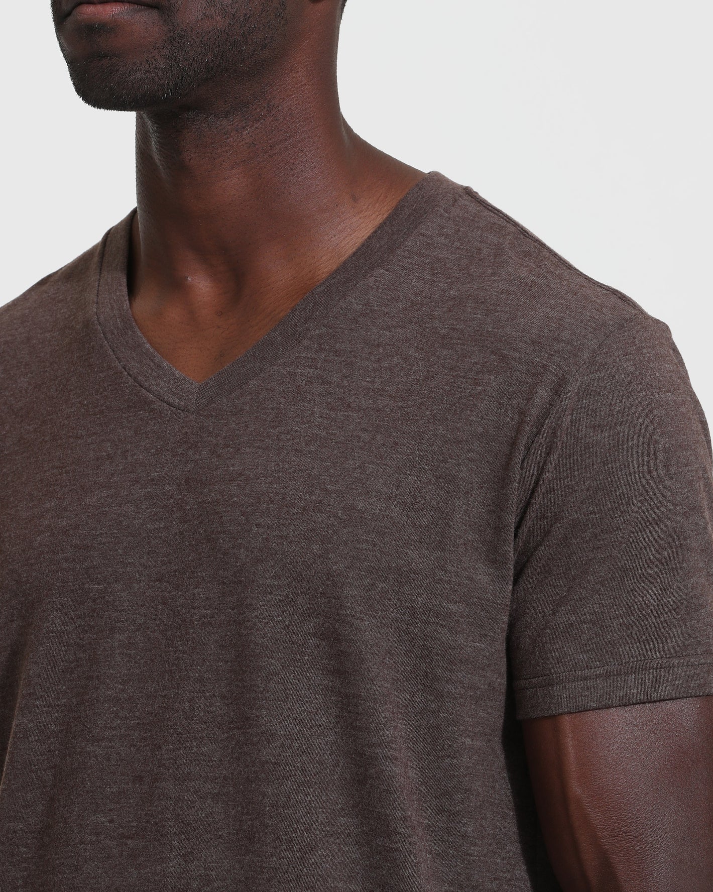 Person wearing Heather Dark Oak Classic V-Neck T-shirt, showcasing its fit.