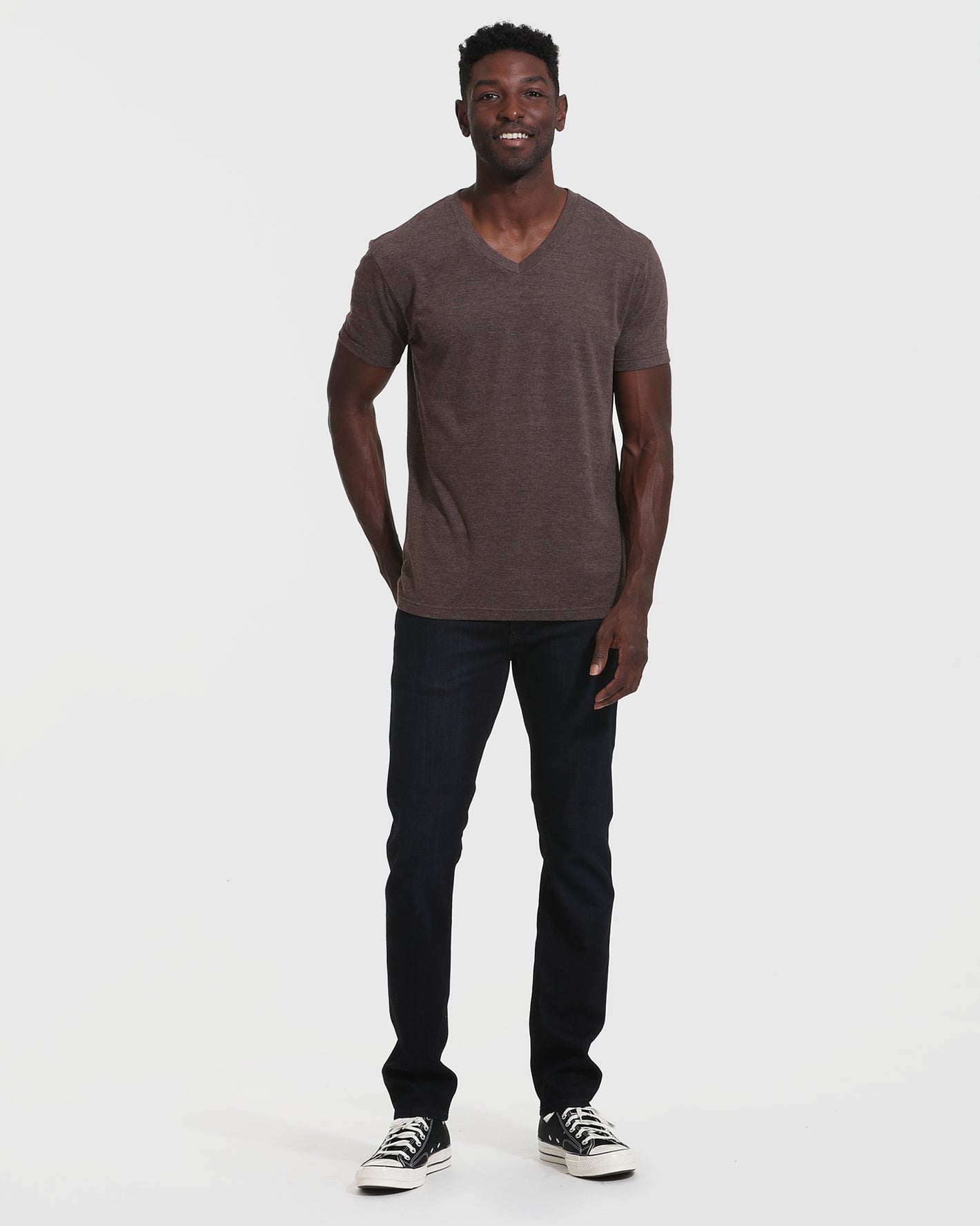 Man wearing Heather Dark Oak Classic V-Neck and dark indigo jeans.