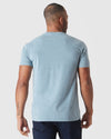 Man in Heather Sapphire Classic V-Neck and jeans, showing back view.