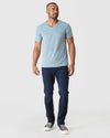 Model wearing Heather Sapphire Classic V-Neck, dark jeans, black sneakers.