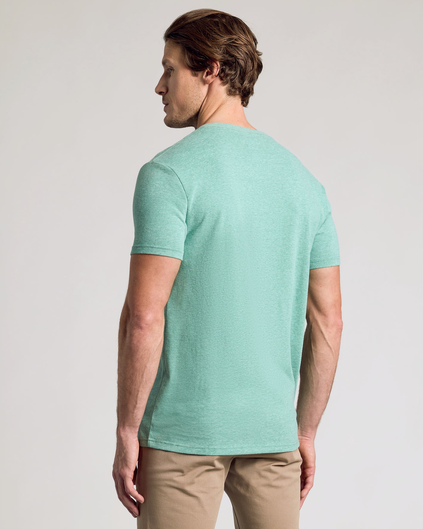 Man in Light Heather Greenery Classic V-Neck, showcasing back fit.