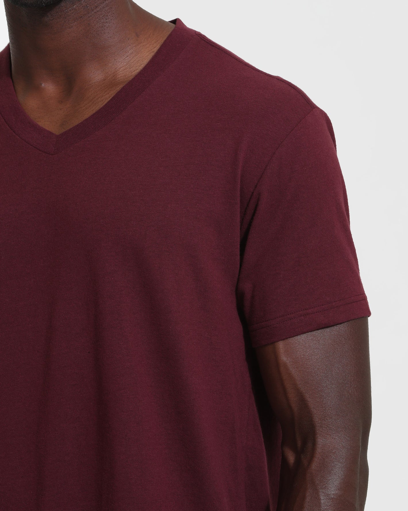 Mahogany V Neck T Shirt on model's upper torso and right arm.