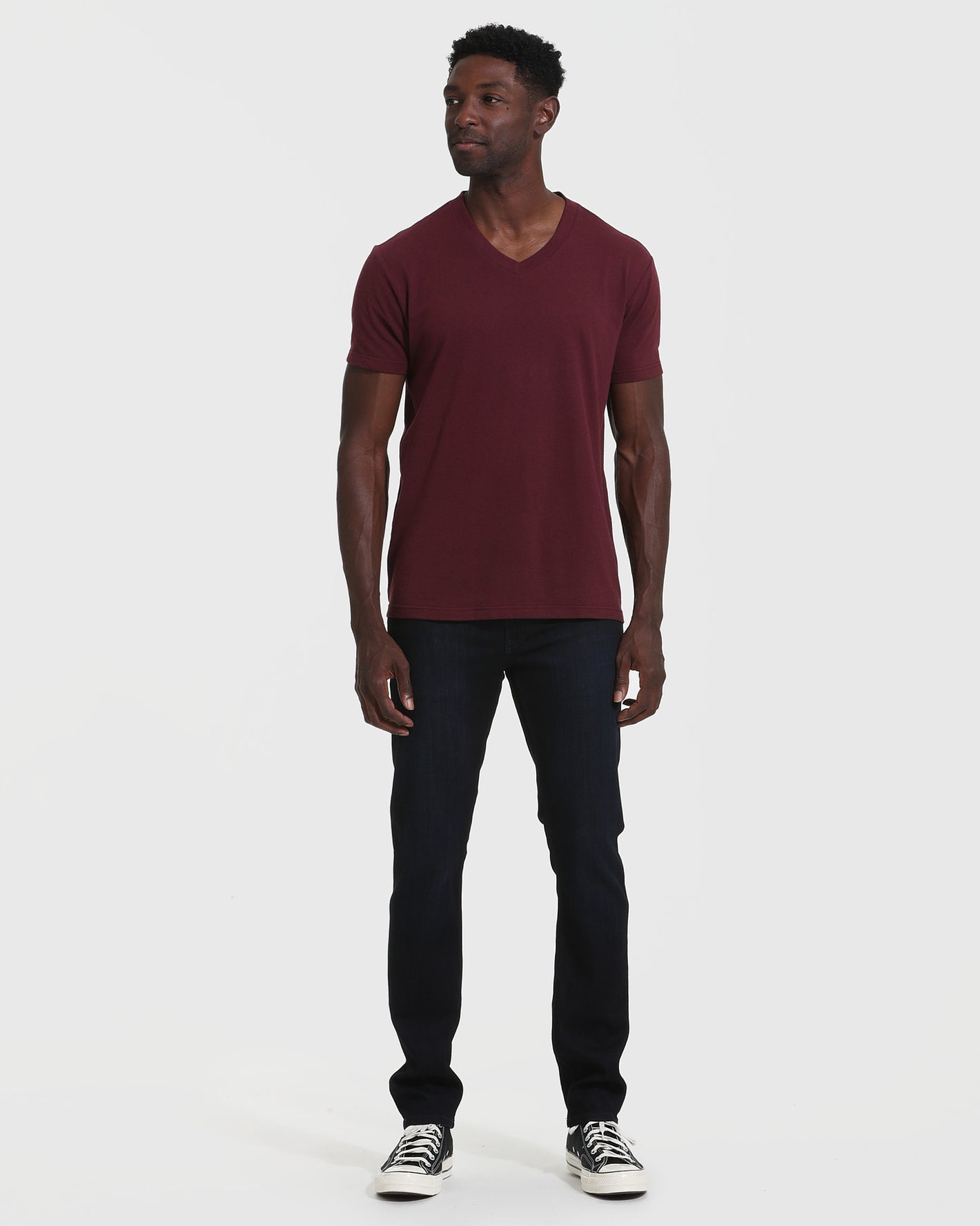 Mahogany V Neck T Shirt on model with jeans and sneakers.