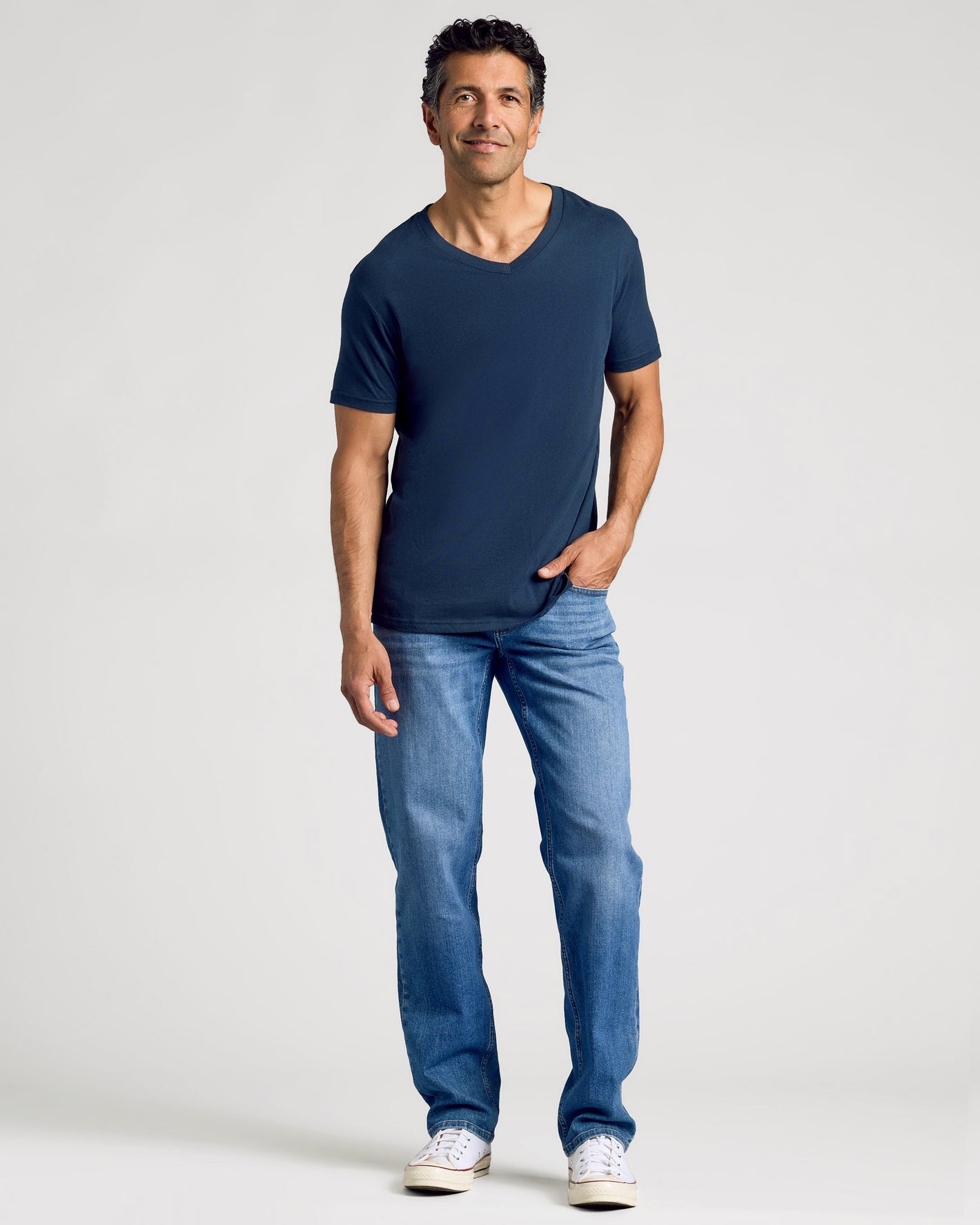 Man wearing Essential V-Neck Tee from 3-Pack, jeans, sneakers.