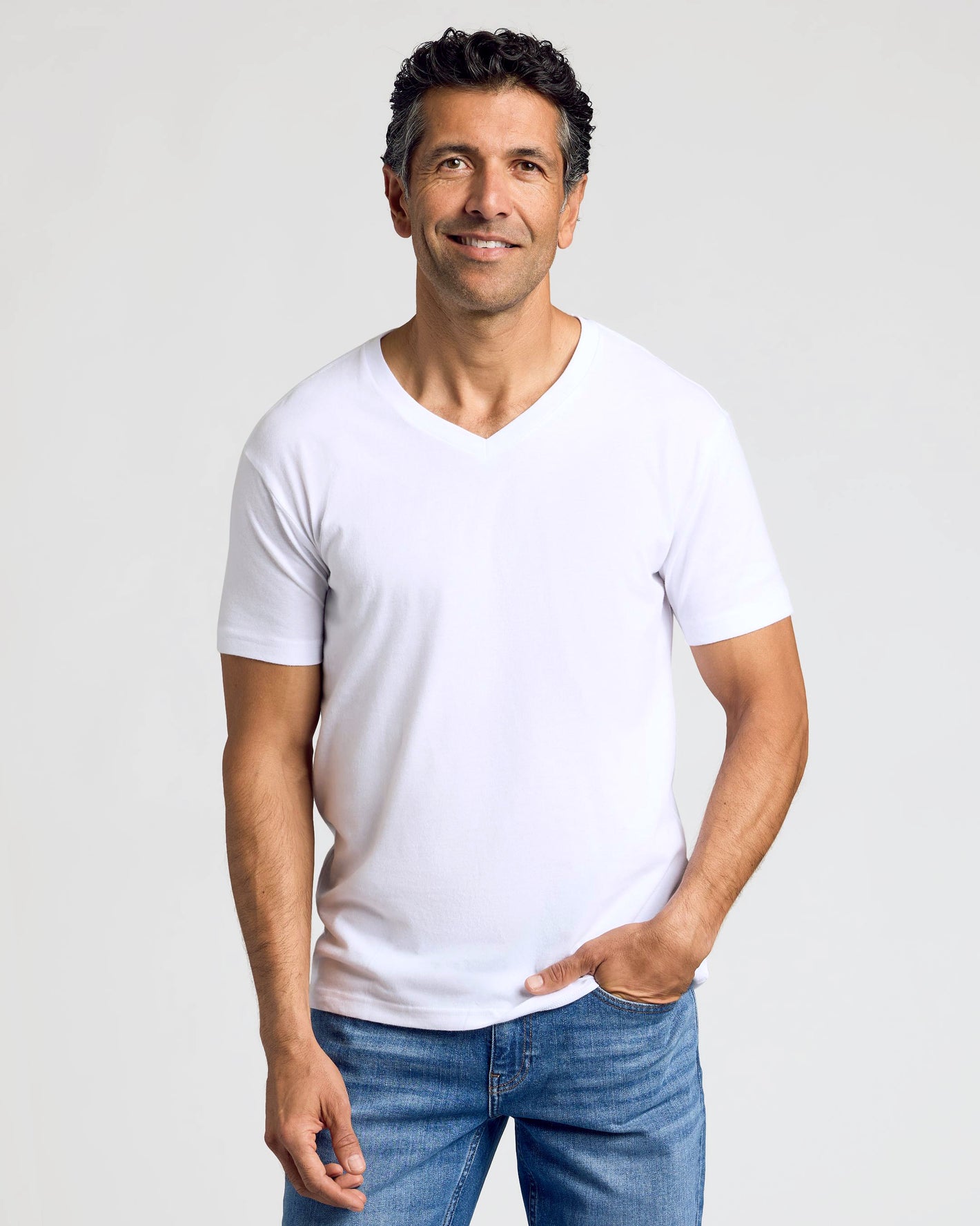 Man wearing All White Classic V-Neck 10-Pack, relaxed stance.