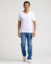 Man in All White Classic V-Neck T-Shirt, relaxed and smiling.