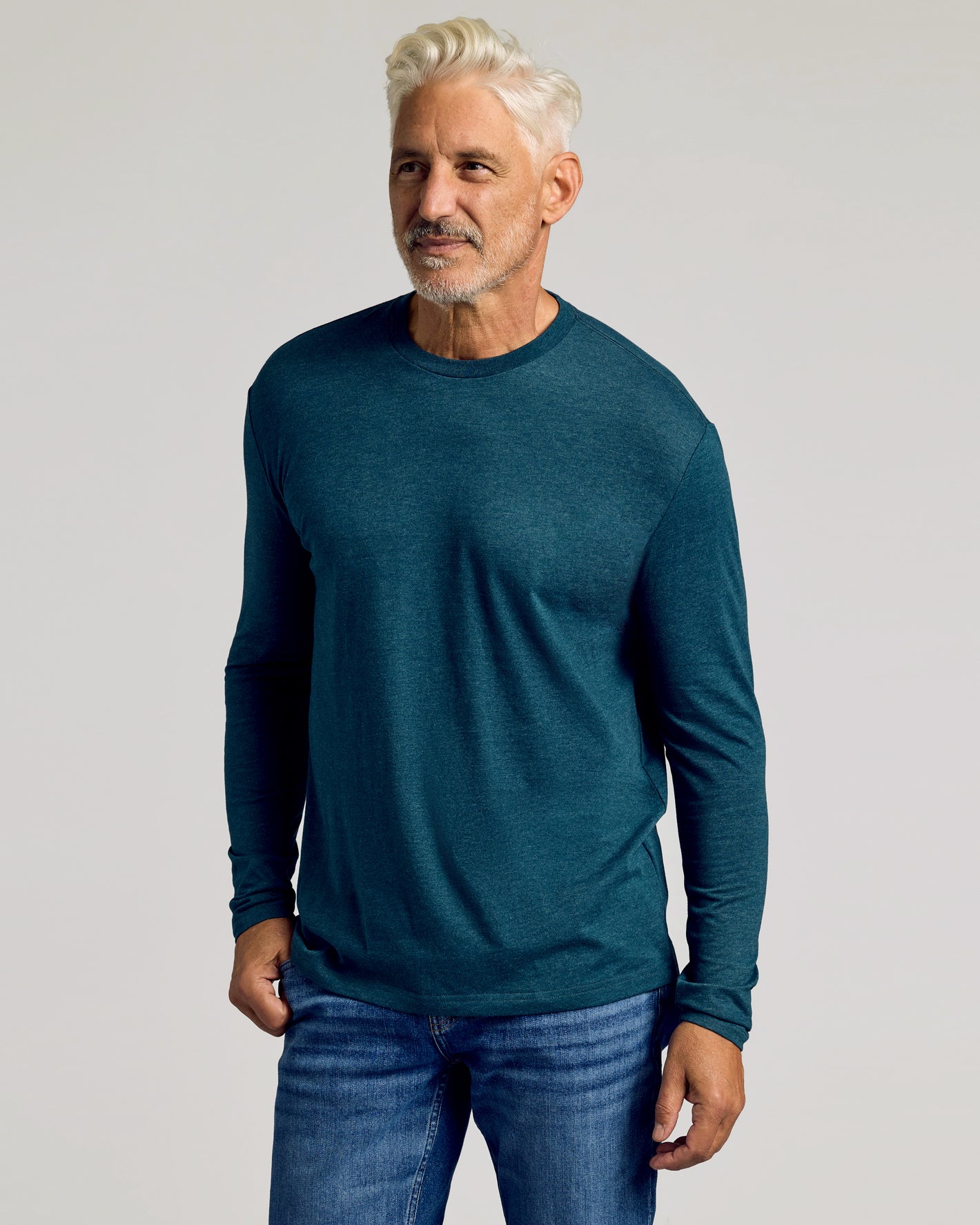 Man wearing Dark Heather Pond Long Sleeve Crew Neck Tee and jeans.